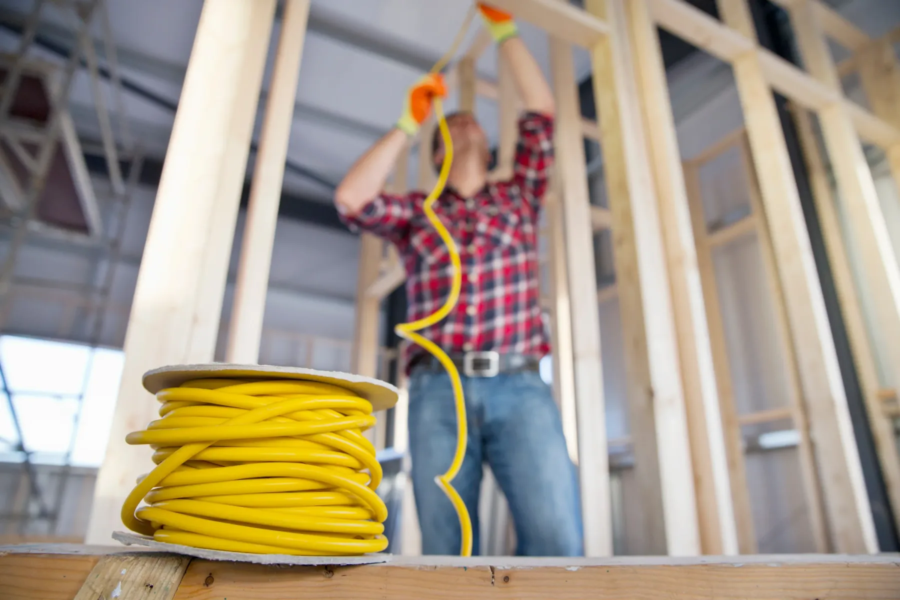 Electrician arranging wiring in a new building.