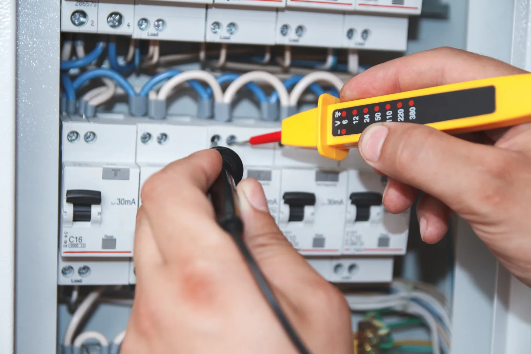 Voltage testing at an electrical panel.